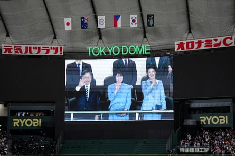 Japanese Emperor Naruhito, Princess Aiko and Empress Masako are seen on the screen after the World Baseball Classic game between Japan and Australia in March 2026.