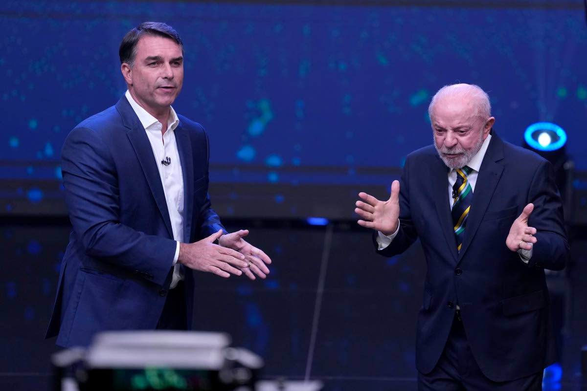 Brazil President Luiz Inacio Lula da Silva (right) who is running for reelection, gestures as opposition presidential candidate Flavio Bolsonaro stands beside him during a televised presidential debate one week before the runoff election in Sao Paulo, Braz